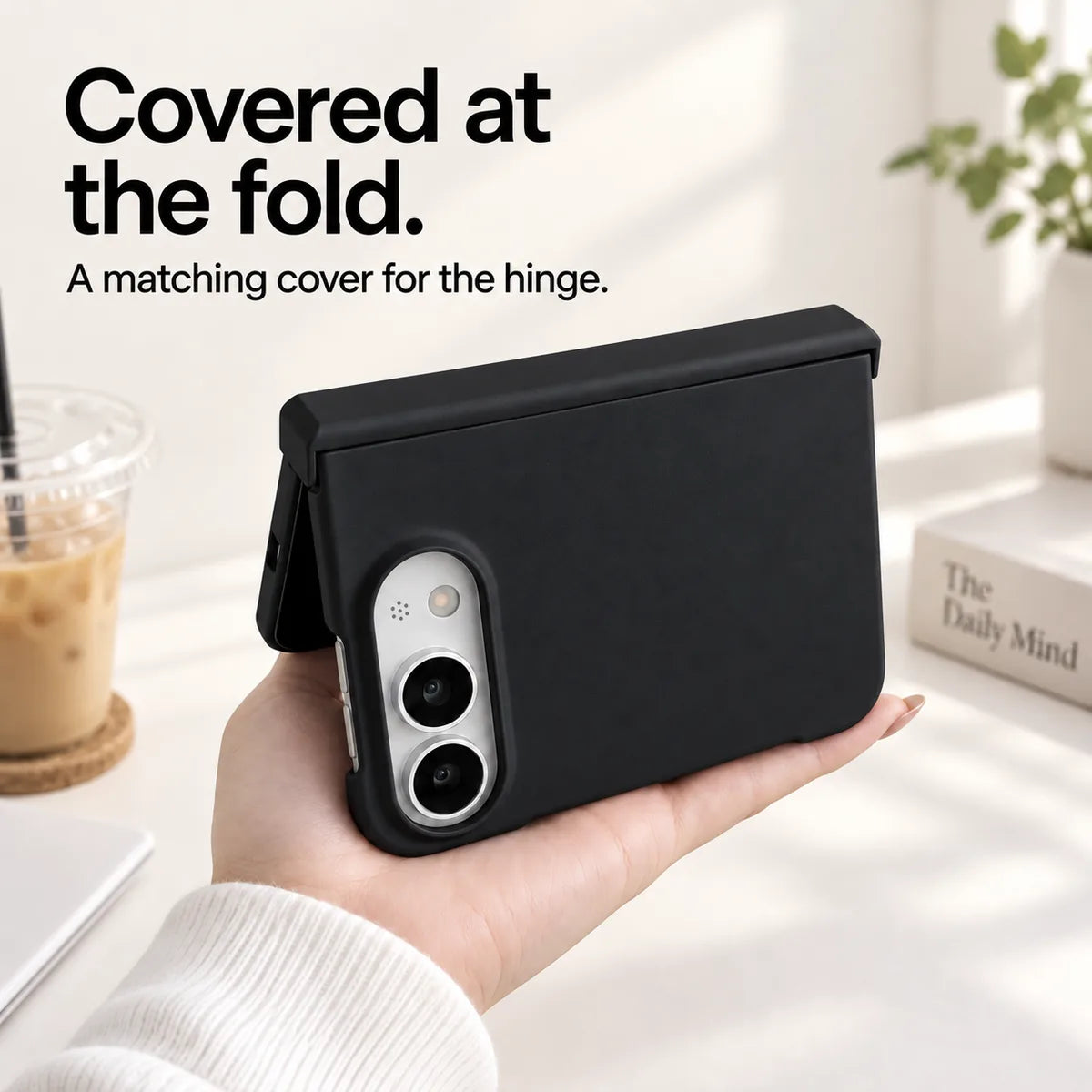 Black iPhone Ultra case held partly folded, showing the matching cover along the hinge. #color_Onyx Black