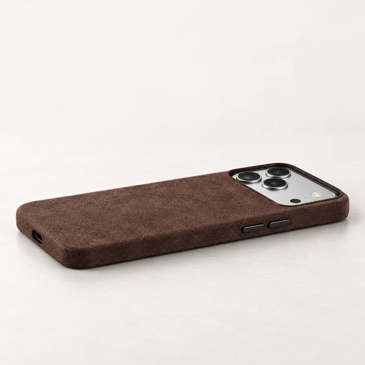 Low side view of a brown fabric phone case showing the fitted button covers.